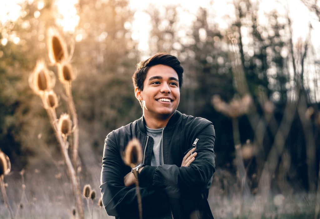 man smiling in field