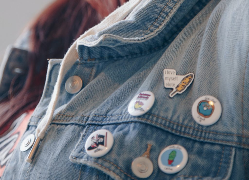 jean jacket with pins on it